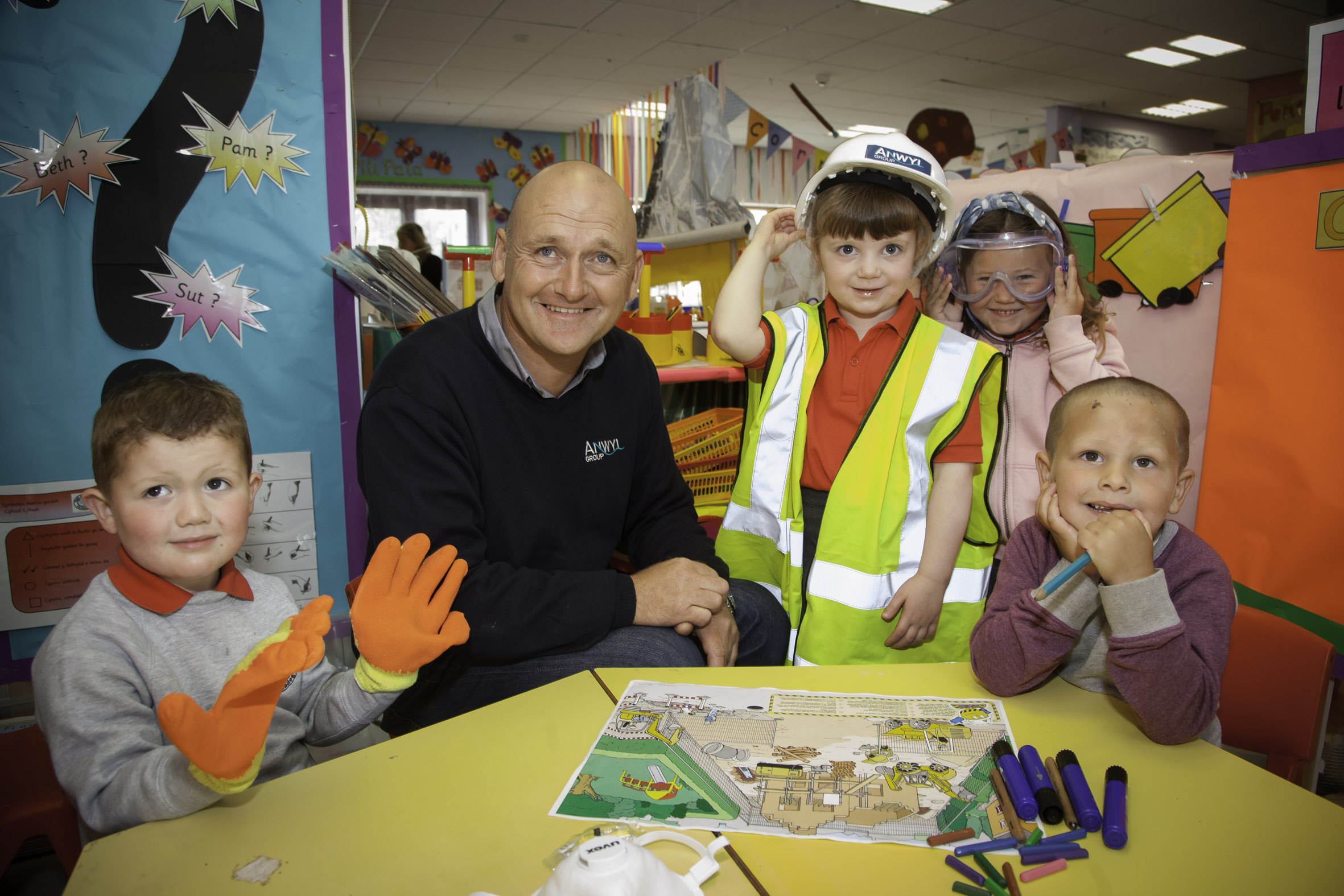 Pupils put on hard hats for a safety lesson from Bob the Builder