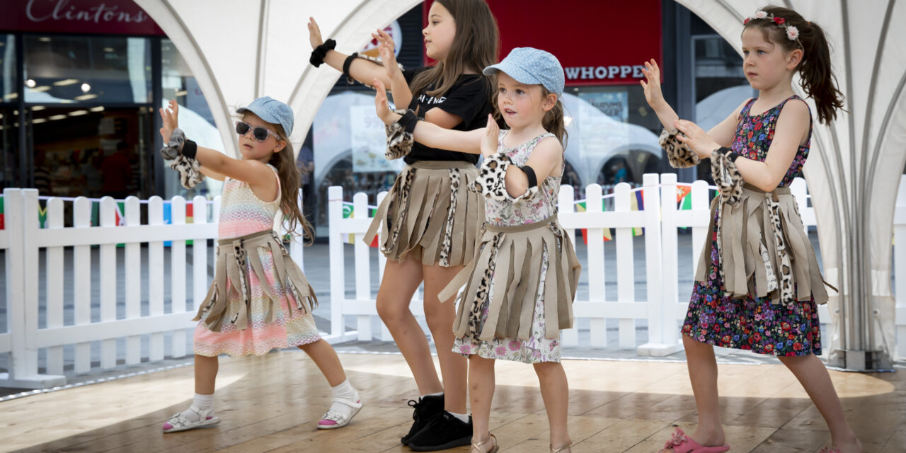 Young shoppers dance to African beat while raising money for centre which helps disabled children
