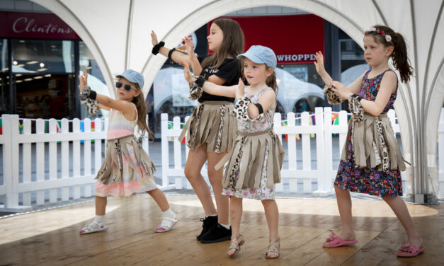 Young shoppers dance to African beat while raising money for centre which helps disabled children