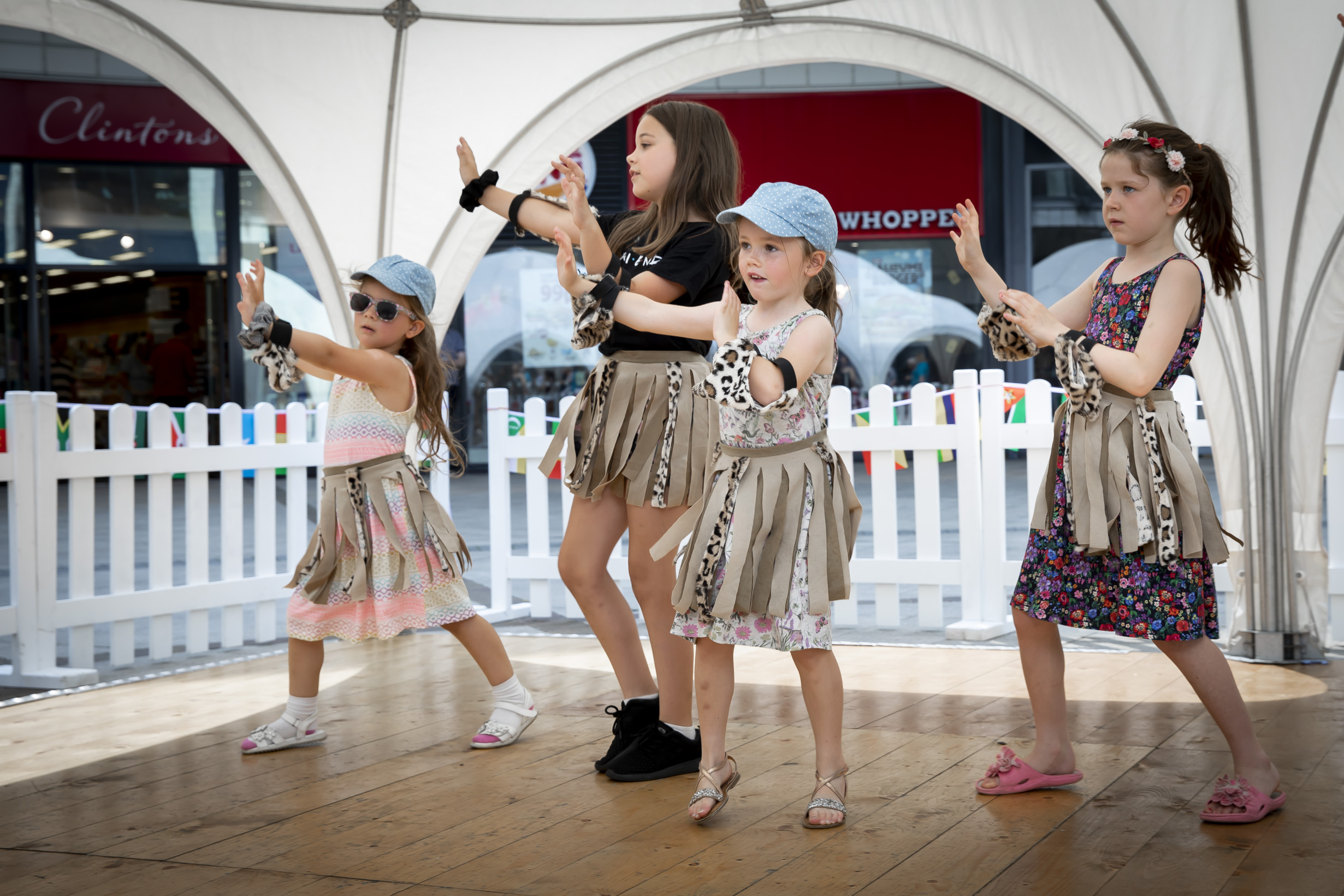 Young shoppers dance to African beat while raising money for centre which helps disabled children