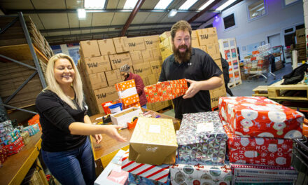 Kind-hearted team pack shoeboxes with Christmas joy