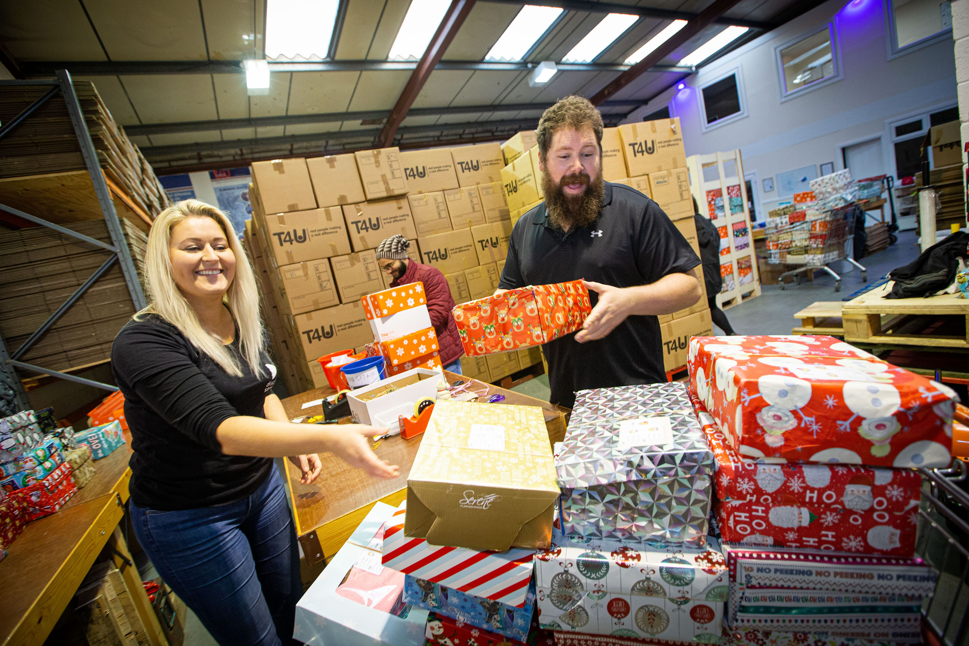 Kind-hearted team pack shoeboxes with Christmas joy