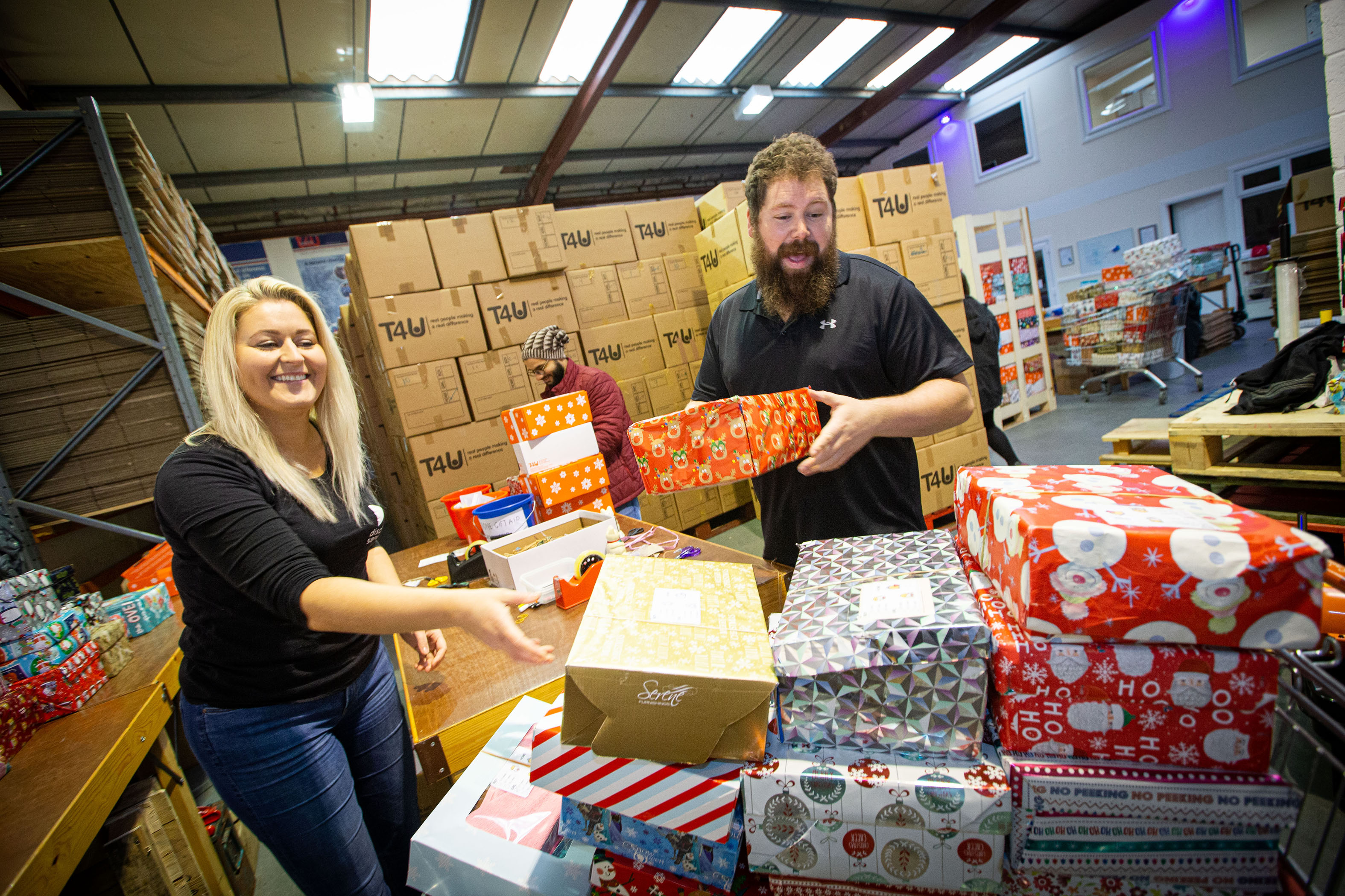 Kind-hearted team pack shoeboxes with Christmas joy