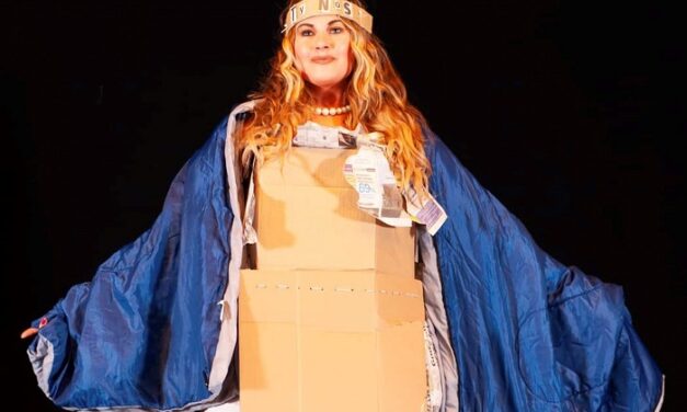 Plus-size model Cat wears cardboard box on catwalk for homeless charity